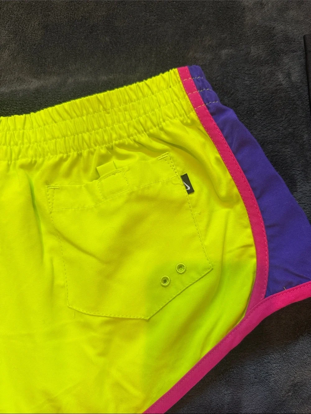 Nike Kid’s Neon Yellow Running Shorts with Pink Trim and Purple Accents